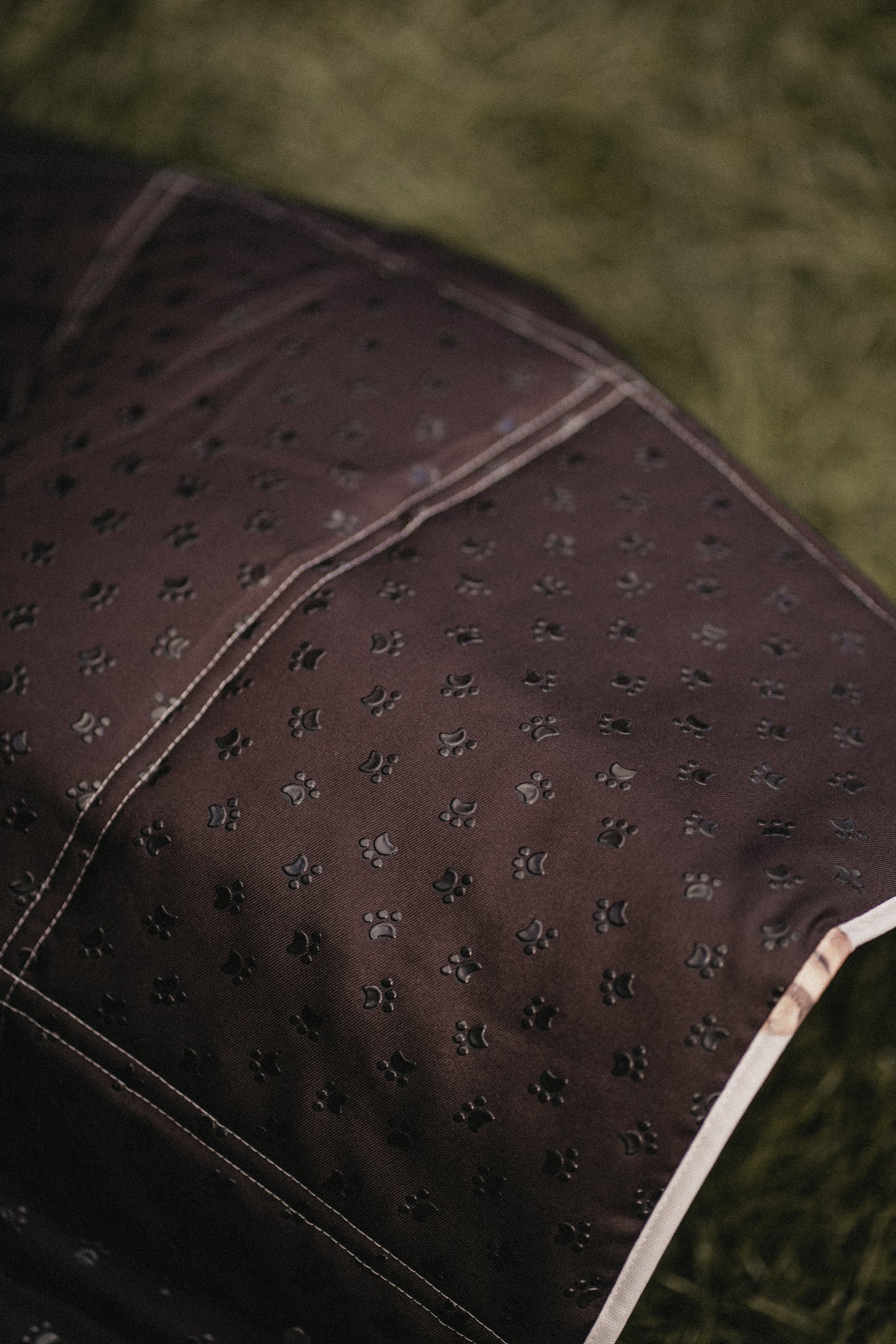 Close-up of a textured brown fabric with a green background